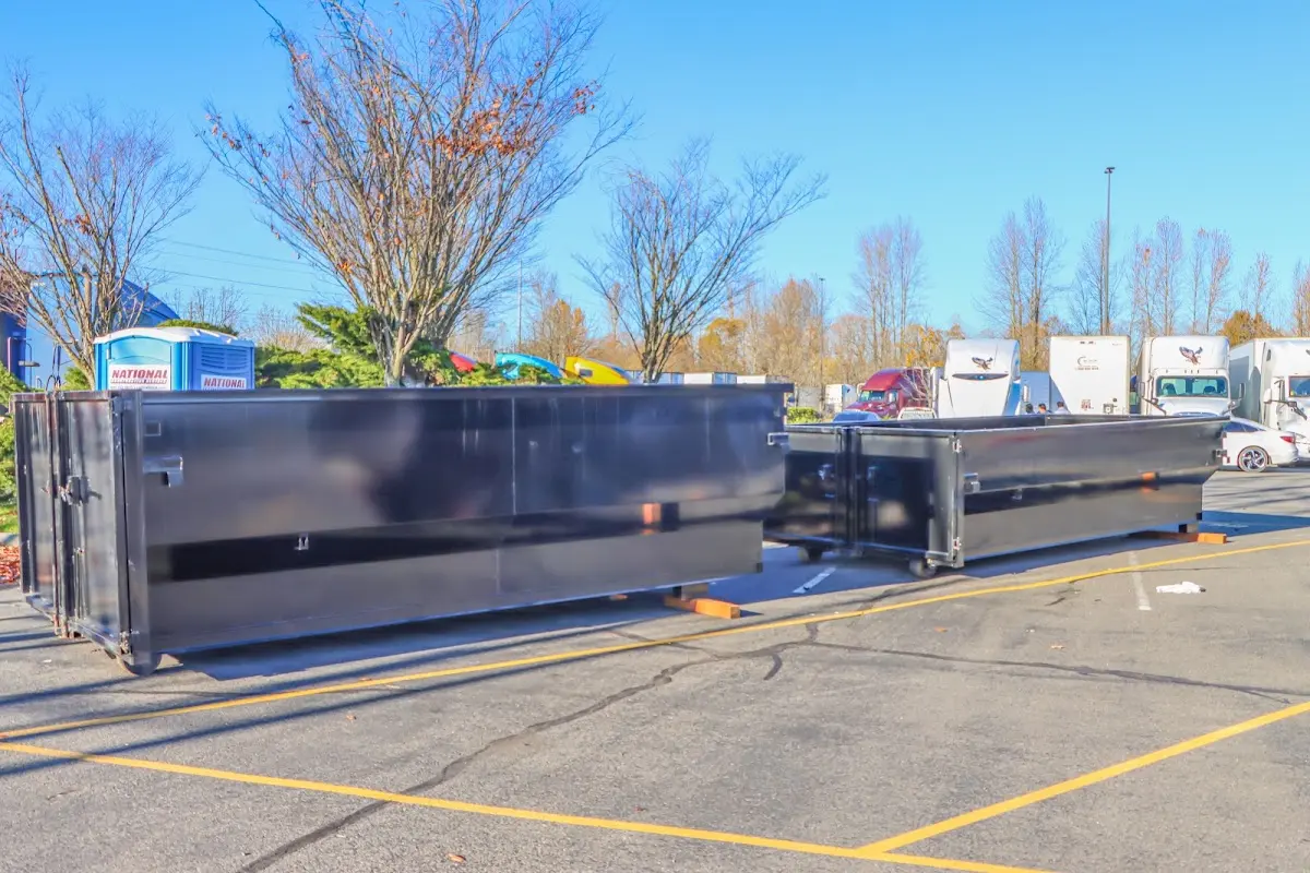 Professional dumpster rental service with roll-off container on residential driveway in Delanco